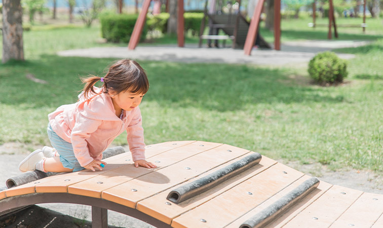 Mädchen klettert auf Spielplatz