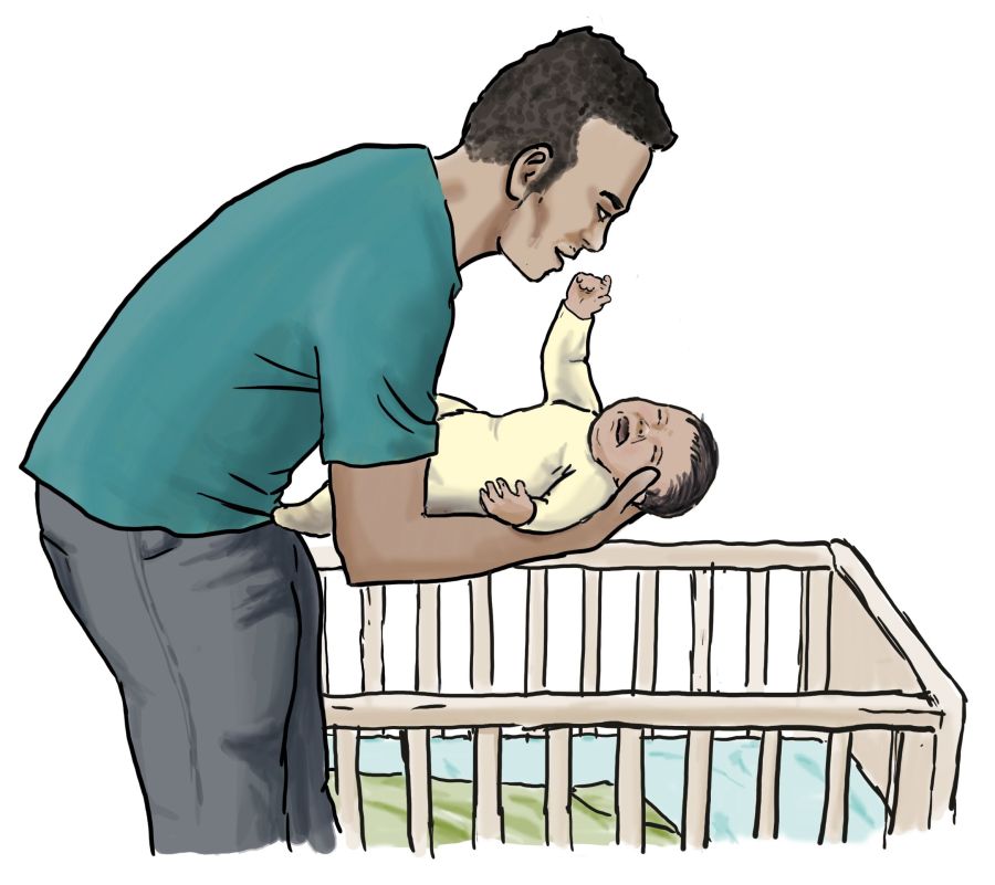 Ein Mann legt ein schreiendes Baby ins Bett. Ein Mann legt ein schreiendes Baby ins Bett.