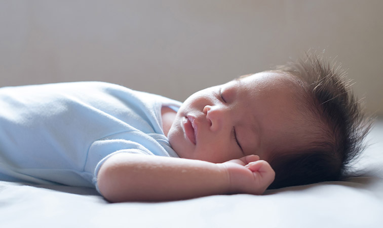 Ein Baby schläft auf dem Rücken